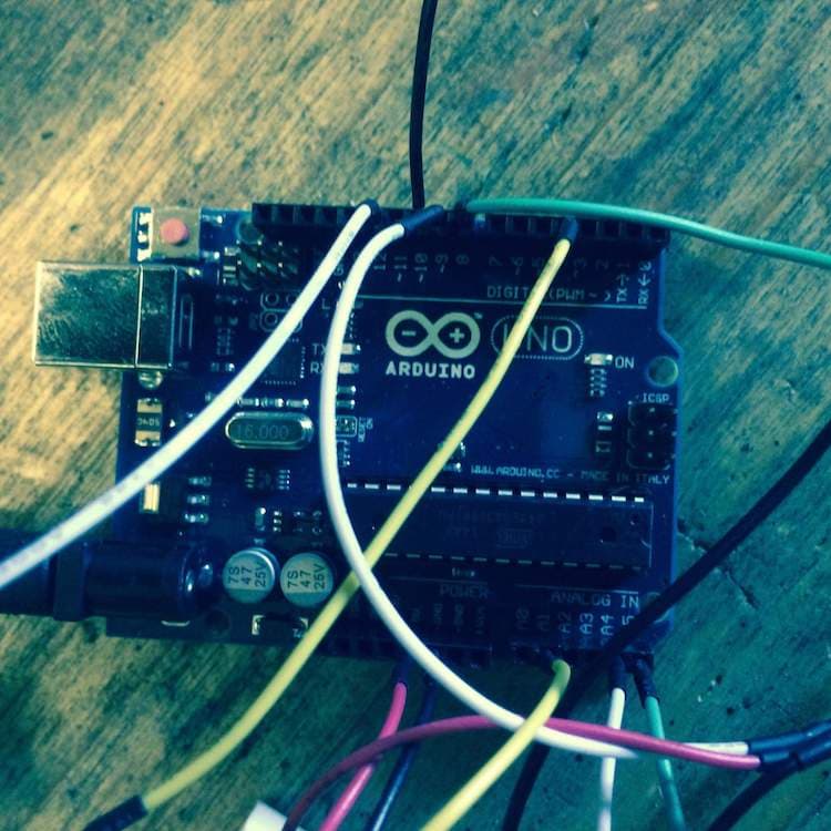 A picture of a microcontroller with wires attached.